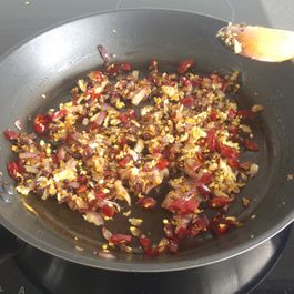 Frying onions, garlic, chilli, and peppercorns