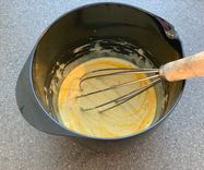 Mixing in the tumeric into the vegan omelette batter