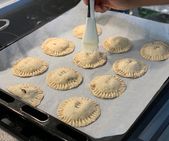 Brushing apple hand pies with plant milk