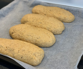 Making mini baguettes out of the herb bread